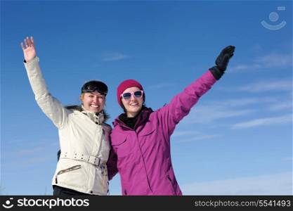 happy friends group of woman girls have fun at winter season at beautiful sunny snow day with blue sky in background
