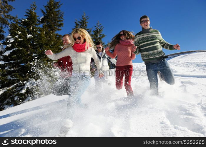 happy friends have fun at winter on fresh snow, healthy young people group outdoor