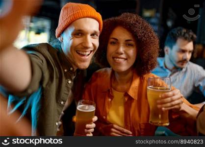 Happy friends holding beer glasses taking selfie photo for memory while rest at sports bar. Happy friends taking selfie photo while rest at sports bar