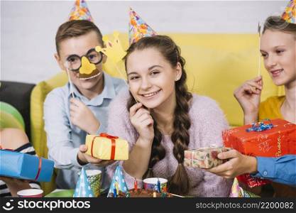 happy friends holding props hand giving gifts smiling teenage girl