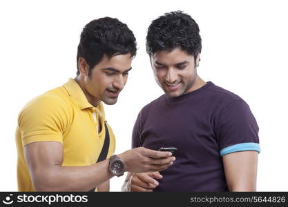 Happy friends reading text message on cell phone