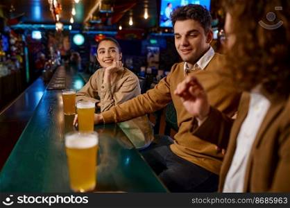 Happy friends resting and talking at sport bar. Group of excited people having beers pub. Friendship and fun time together. Group of happy friends resting and talking at bar or pub