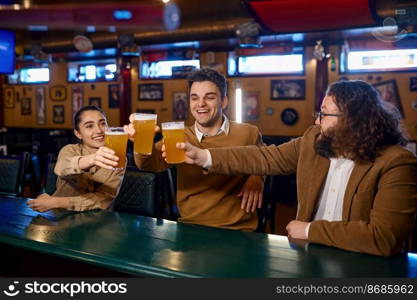 Happy friends resting and talking at the bar. Group of excited people having beers pub. Friendship and fun time together. Group of happy friends resting and talking at bar