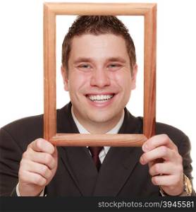 Happy funny business man guy framing his face with wooden empty picture frame isolated on white background