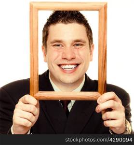 Happy funny business man guy framing his face with wooden empty picture frame isolated on white background