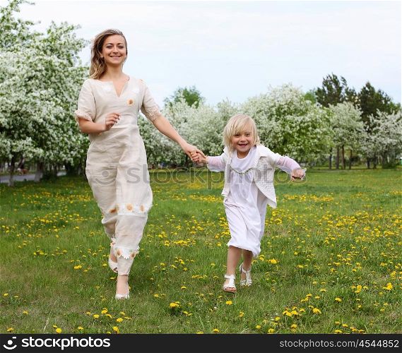 happy girl and her mother in the spring park