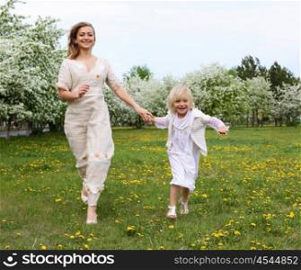 happy girl and her mother in the spring park