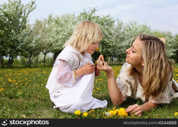 happy girl and her mother in the spring park