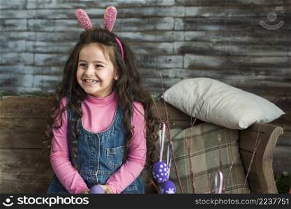 happy girl bunny ears with easter eggs