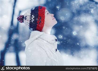 happy girl catches snowflakes mouth