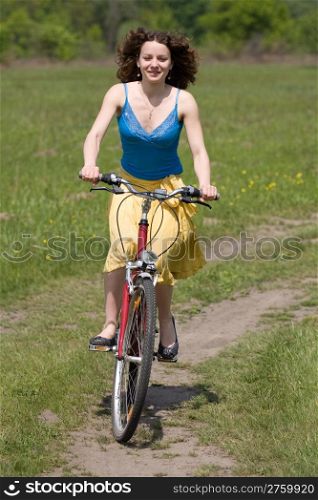 happy girl goes by bicycle