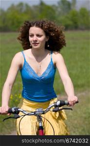 happy girl goes by bicycle