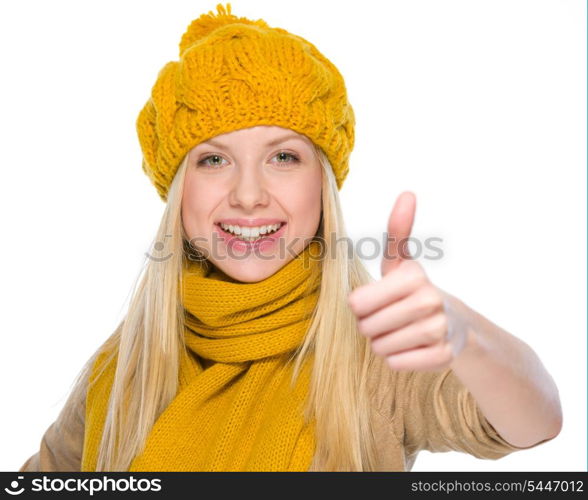 Happy girl in autumn clothes showing thumbs up