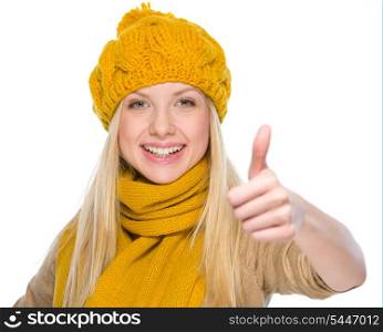Happy girl in autumn clothes showing thumbs up