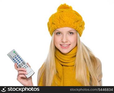 Happy girl in autumn clothes with tv remote control