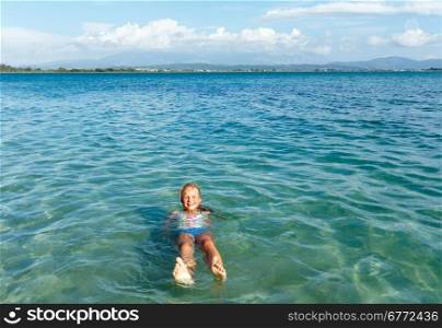 Happy girl in sea clean water (Lefkada, Greece).