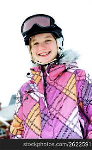 Happy girl in ski helmet at winter resort