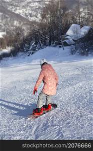 happy girl in ski resort riding snowboard. winter sports