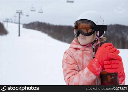 happy girl in ski resort riding snowboard. winter sports