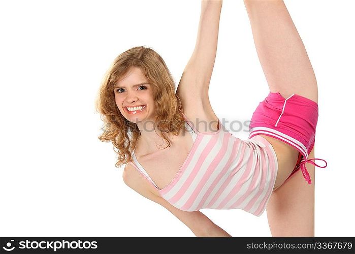 Happy girl in sportswear does gymnastic exercise