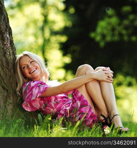 happy girl lying under a tree on a summer day