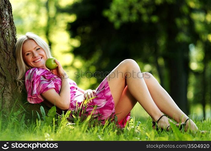 happy girl lying under a tree on a summer day