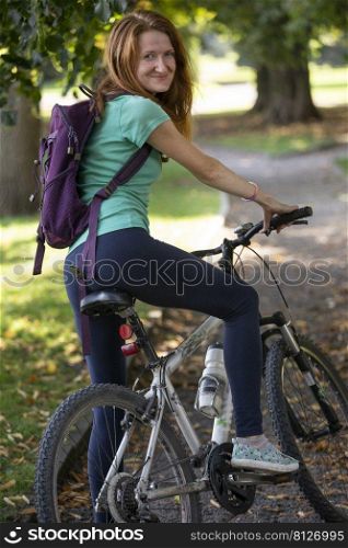 happy girl on a bike at the park 