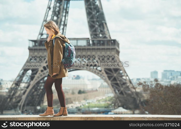 happy girl on the background of the Eiffel Tower in Paris. France