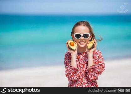 Happy girl on the beach having fun. Cute little girl at beach during summer vacation