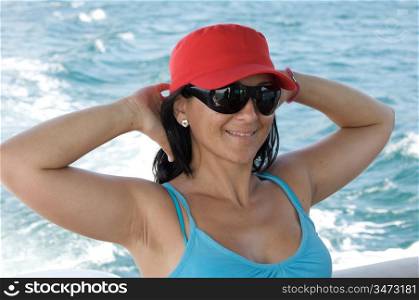 Happy girl on vacation at sea with sunglasses