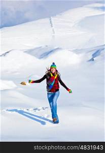Happy girl running in the snow, teen outdoor winter activities, female having fun at Christmastime, woman wearing colorful clothes, freedom and nature joy concept
