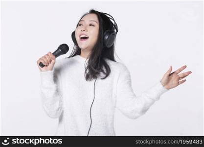 Happy girl singing with a microphone