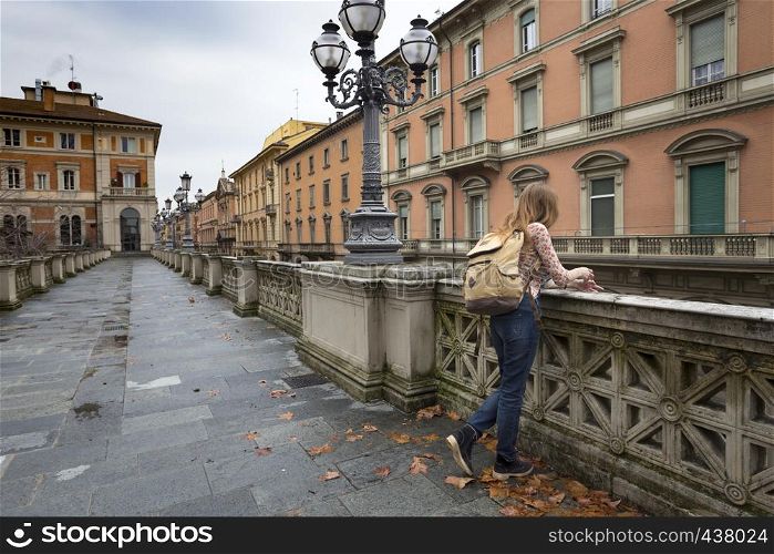 happy girl standing near parapet and looking at the Bologna. italy