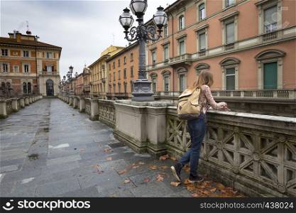 happy girl standing near parapet and looking at the Bologna. italy