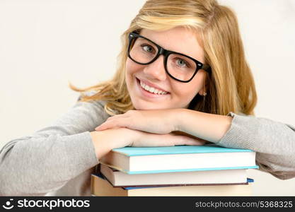 Happy girl student with stack of books smiling on white