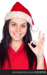 Happy girl with Christmas hat saying Ok isolated on a over white background