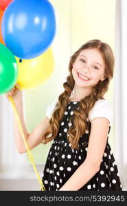 happy girl with colorful balloons at home