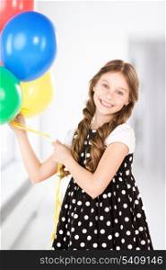 happy girl with colorful balloons at home