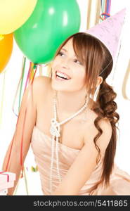 happy girl with colorful balloons in party cap