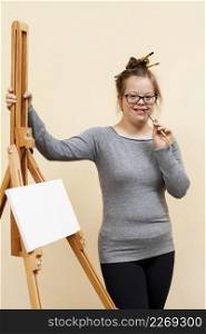 happy girl with down syndrome posing easel
