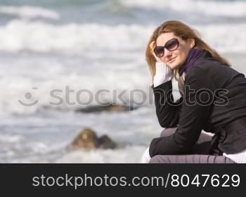 Happy girl with glasses on the background of the sea