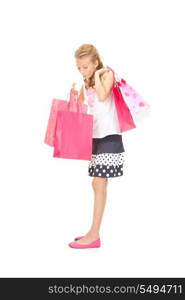 happy girl with shopping bags over white