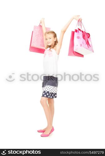 happy girl with shopping bags over white