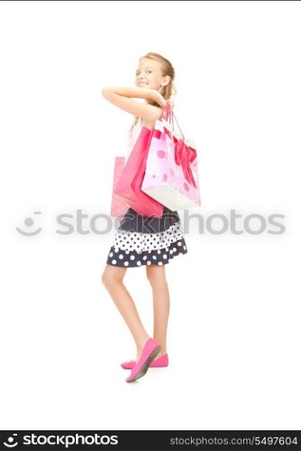 happy girl with shopping bags over white