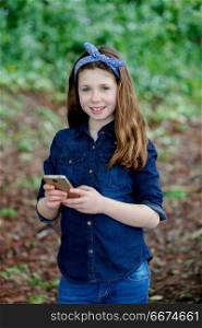 Happy girl with ten years old holding a phone . Happy girl with ten years old holding a phone in a park