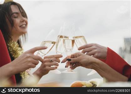happy girls cheering up glasses champagne