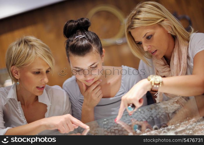 happy girls group have fun while shopping in jewelry store