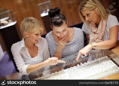 happy girls group have fun while shopping in jewelry store