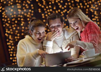 happy girls group looking at a pc tablet in a home interior and have fun