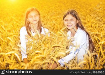 Happy girls meadow weat field